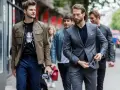 Hombres con estilo, uno con chaqueta y camiseta estampada, otro con traje gris. Dress code casual.