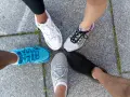 Cinco pares de zapatillas deportivas de colores, listas para evitar esguinces en cualquier aventura.