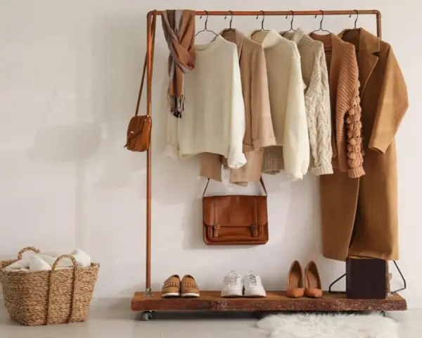 Un armario cápsula mujer con prendas de punto, abrigos y bolsos en tonos tierra. Perfecto para un estilo minimalista y chic.