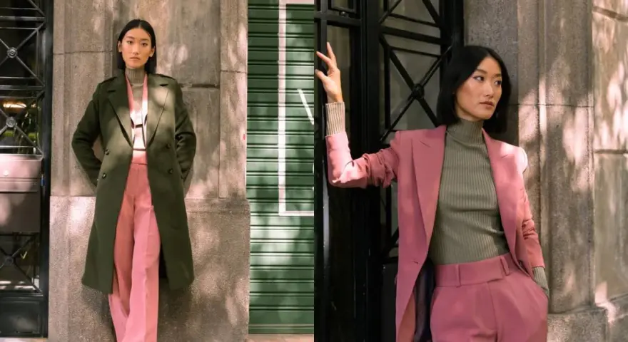 Mujer posa con un traje rosa y un abrigo verde. Inspírate para combinar traje verde mujer con estilo.