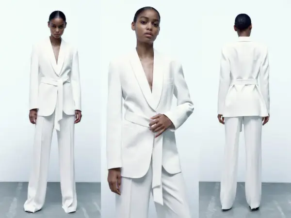 Mujer posa con un elegante traje blanco de pantalón y blazer con cinturón. Un look sofisticado para combinar traje blanco mujer.